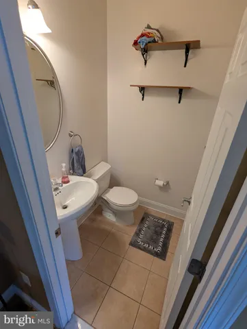 a bathroom with a sink a toilet a mirror and shower