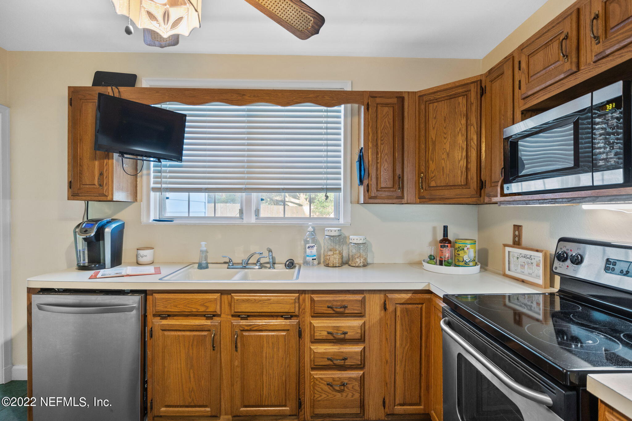 1408 Nicholson Road Jacksonville, FL 32207 - Photo 12 of 25 a kitchen with stainless steel appliances granite countertop a sink stove and microwave