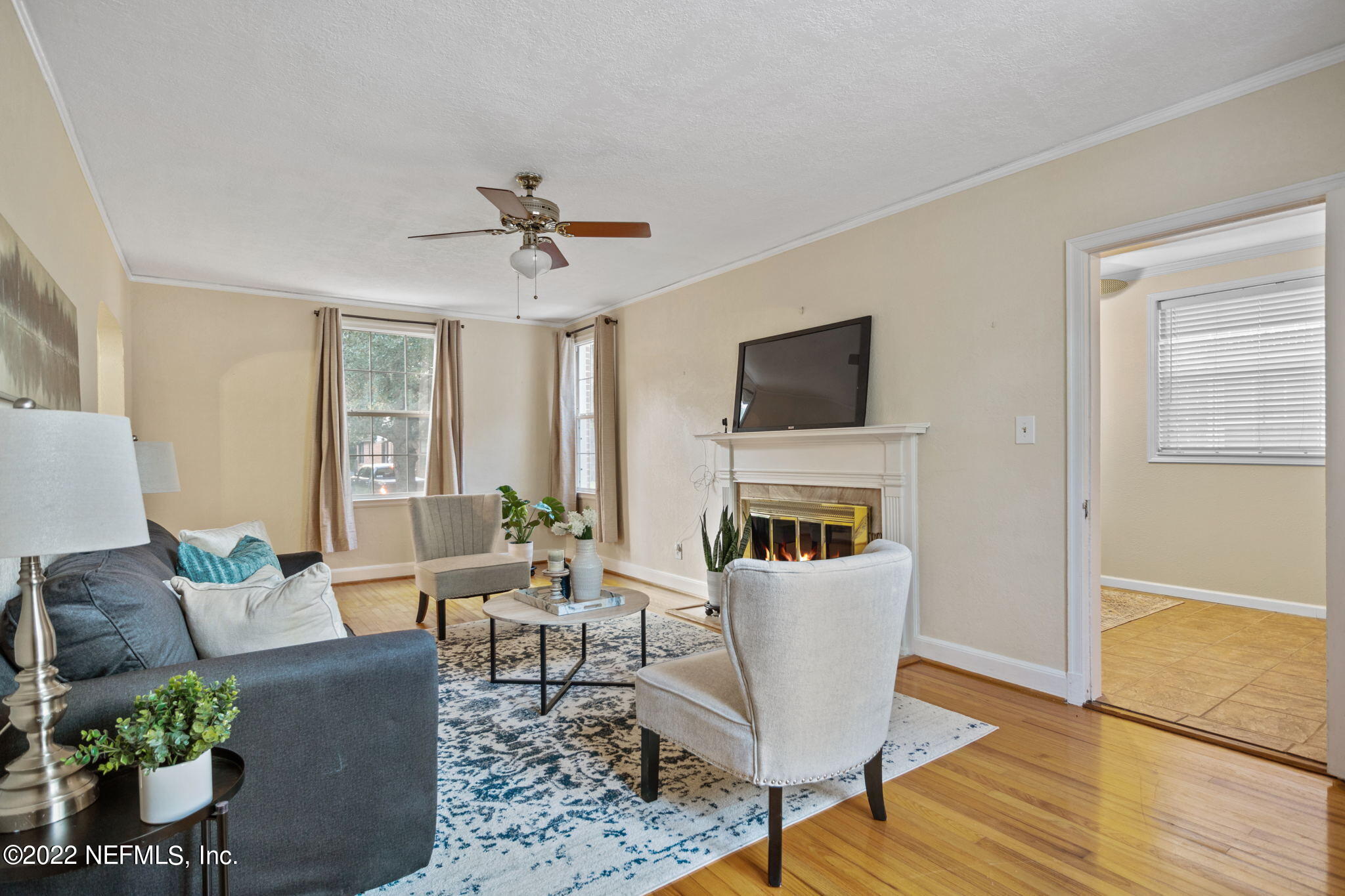 1408 Nicholson Road Jacksonville, FL 32207 - Photo 6 of 25 a living room with furniture a fireplace and a flat screen tv