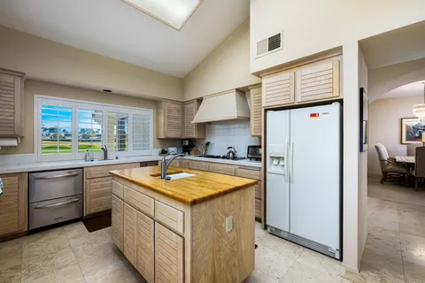 a kitchen with stainless steel appliances granite countertop refrigerator sink and stove