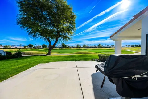 a view of a park with furniture and garden