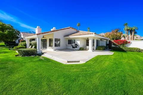 a view of a house with a backyard porch and sitting area