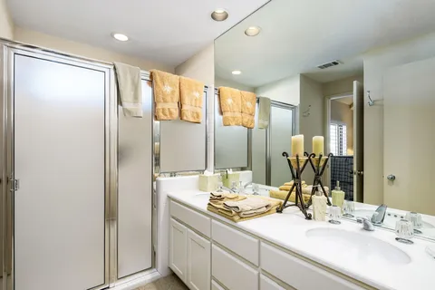 a bathroom with a double vanity sink and mirror