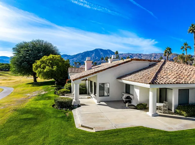a view of a house with swimming pool and a yard
