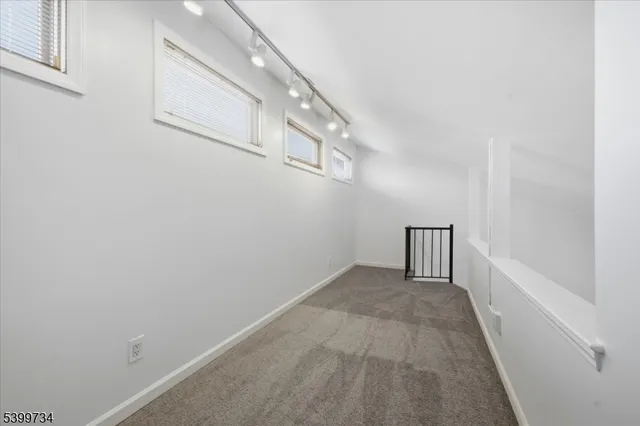 a view of a hallway view with staircase