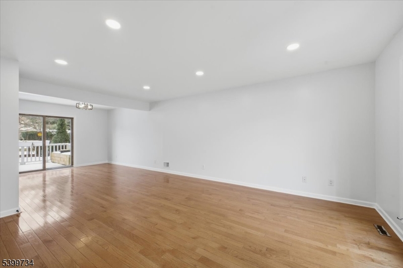 103 Cheyenne Road Lafayette, NJ 07848 - Photo 3 of 27 a view of an empty room with wooden floor and a window