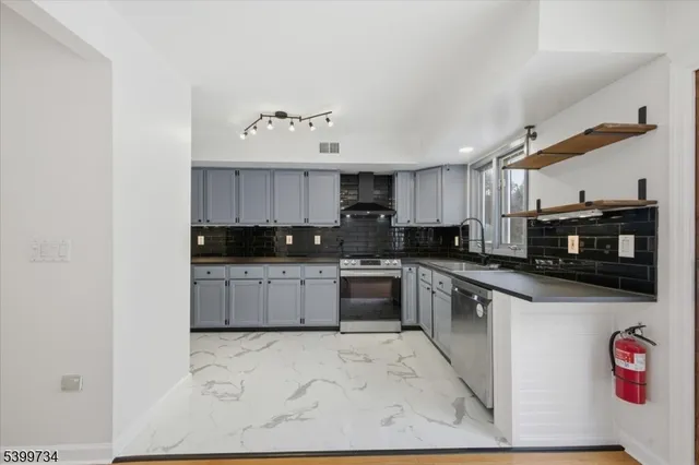 a kitchen with stainless steel appliances and white cabinets