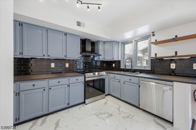 103 Cheyenne Road Lafayette, NJ 07848 - Photo 9 of 27 a kitchen with stainless steel appliances granite countertop a sink a stove a microwave a counter top space and cabinets