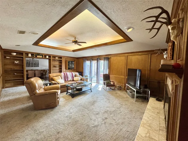 a bedroom with furniture and a large window