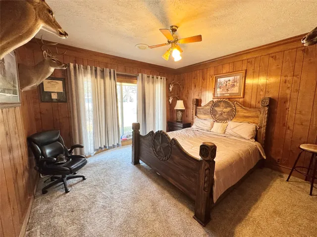 a large bedroom with a bed and large windows