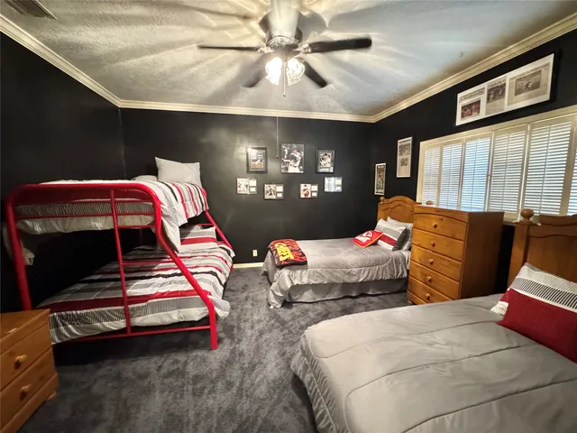 a bedroom with furniture and a flat screen tv