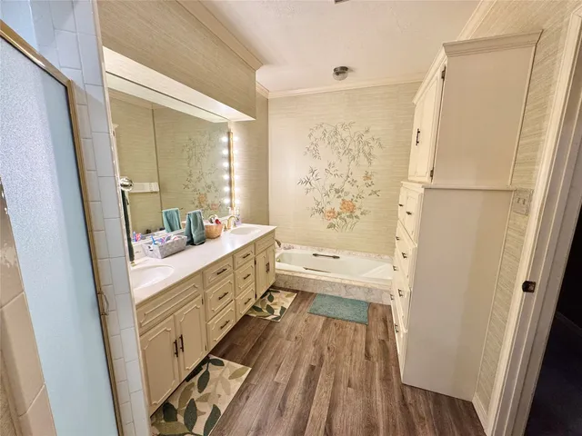 a bathroom with a double vanity sink a mirror and a shower