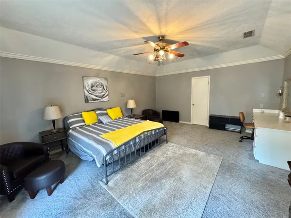 a bedroom with a bed and a chandelier