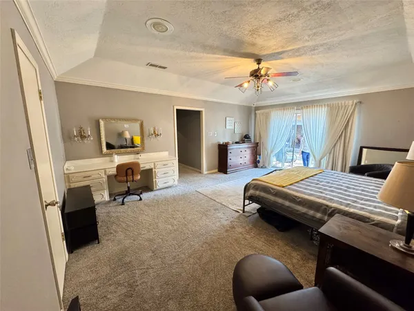 a bedroom with a bed a couch and dresser