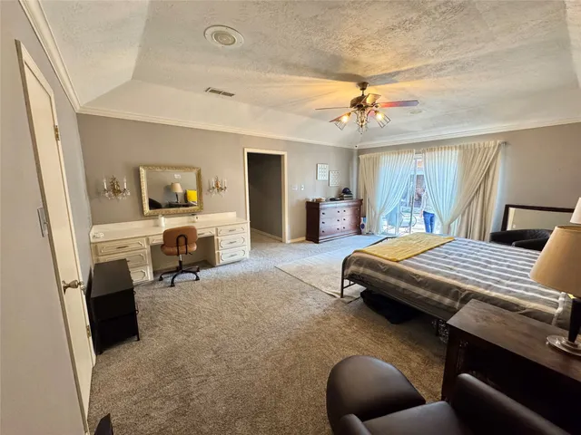 a bedroom with a bed a couch and dresser