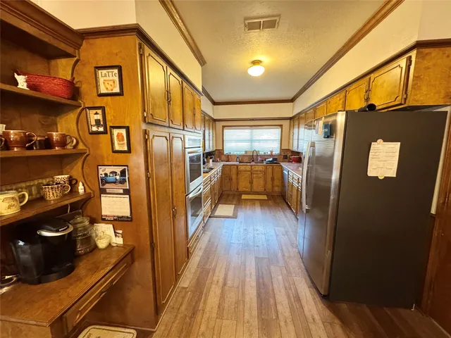 a view of a kitchen with furniture and wooden floor