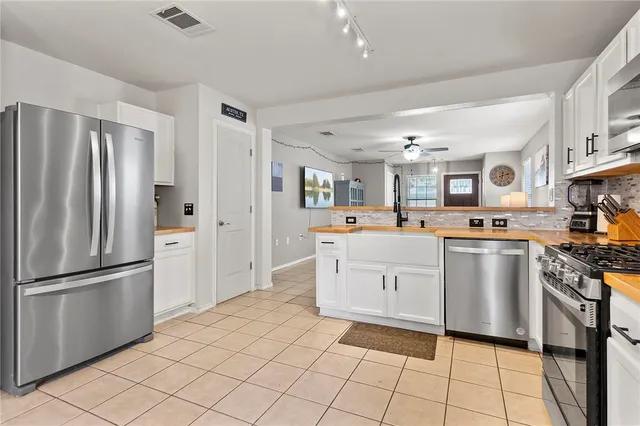 a kitchen with a refrigerator and a sink