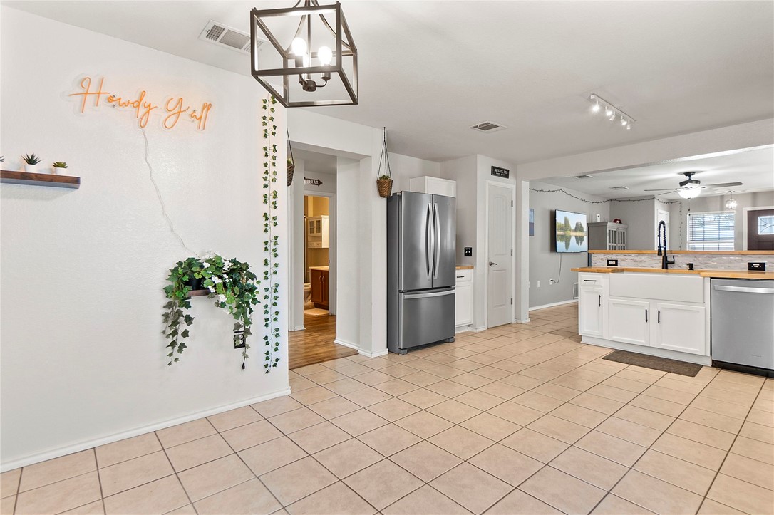 5908 Silver Screen Drive Austin, TX 78747 - Photo 14 of 24 a kitchen with a refrigerator and a sink