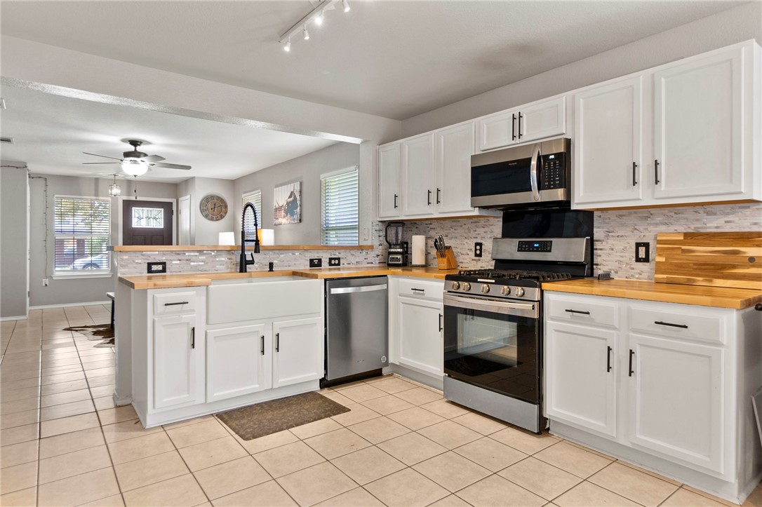 5908 Silver Screen Drive Austin, TX 78747 - Photo 3 of 24 a kitchen with white cabinets appliances and a window