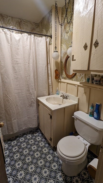 28 Bushwick Place Springfield, MA 01109 - Photo 9 of 24 a bathroom with a sink toilet and shower
