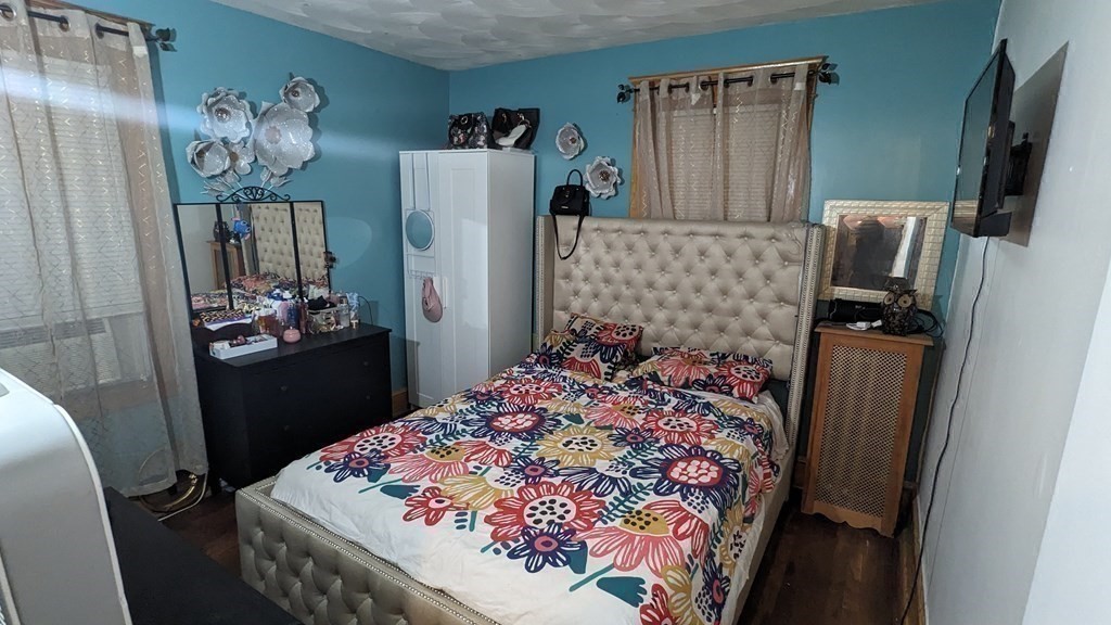 28 Bushwick Place Springfield, MA 01109 - Photo 10 of 24 a bedroom with a bed and a mirror
