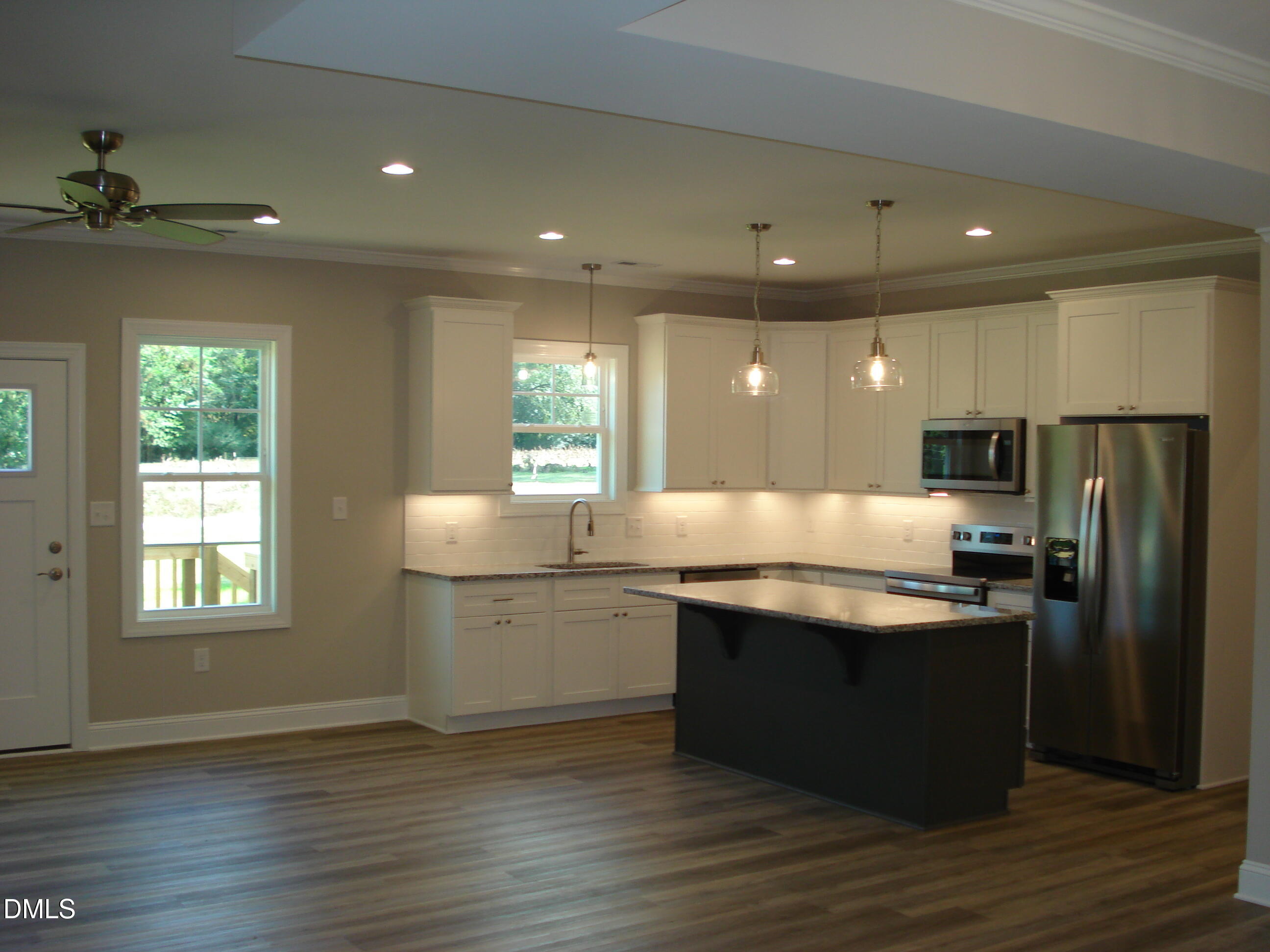 93 Big J Street Erwin, NC 28339 - Photo 18 of 56 a kitchen with stainless steel appliances granite countertop a sink a stove and a refrigerator