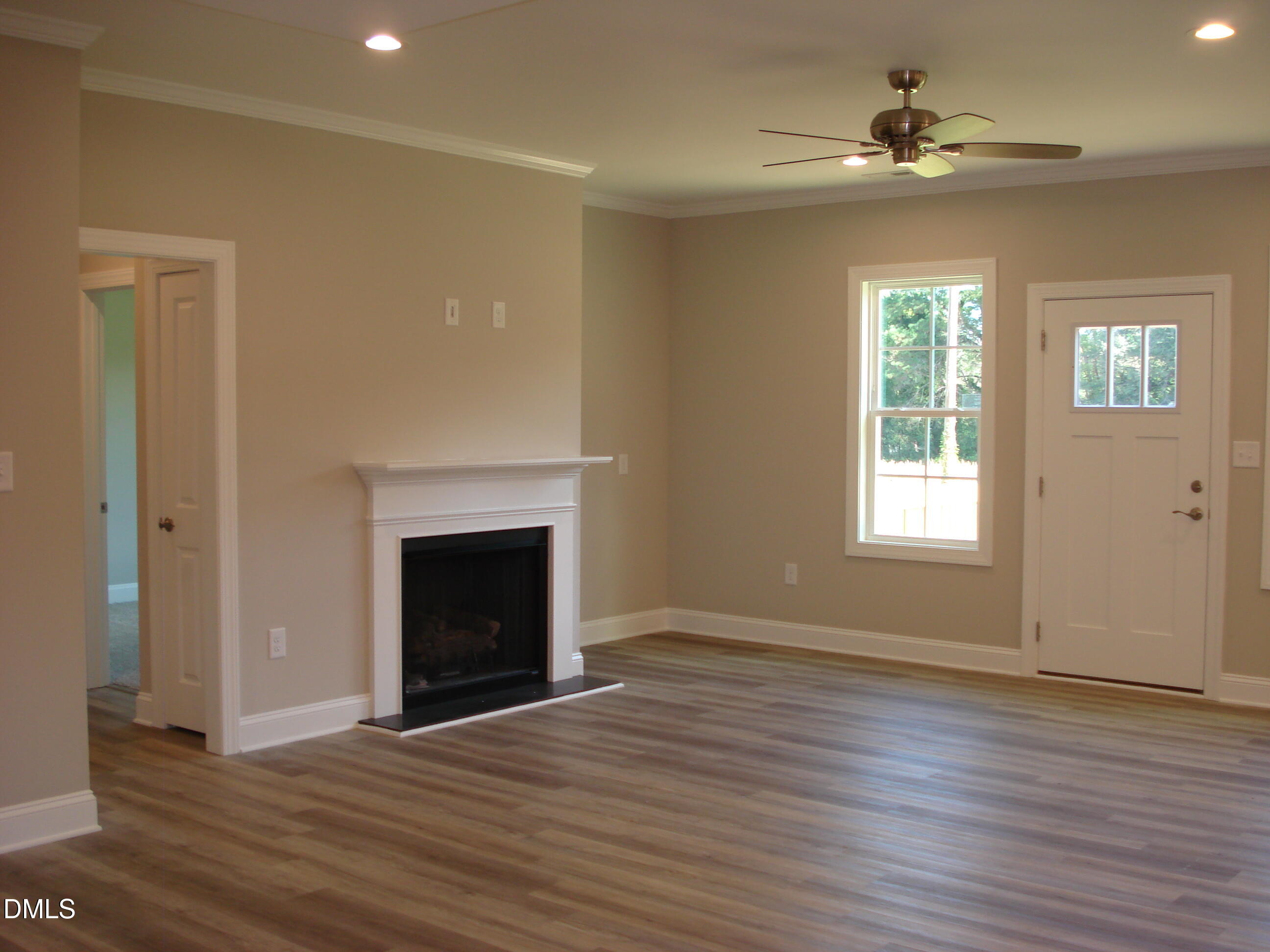 93 Big J Street Erwin, NC 28339 - Photo 19 of 56 a view of an empty room with wooden floor fireplace and a window