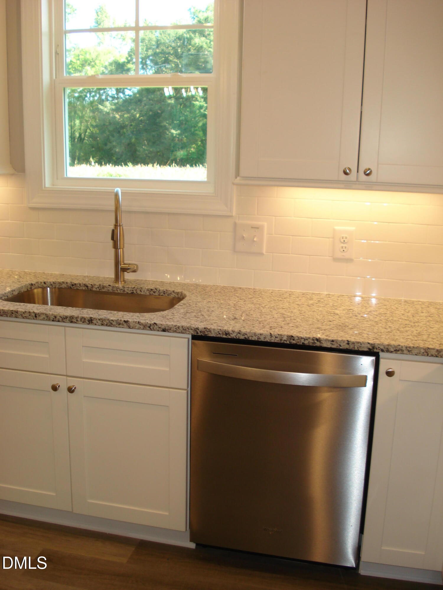 93 Big J Street Erwin, NC 28339 - Photo 31 of 56 a kitchen with granite countertop a sink window and cabinets