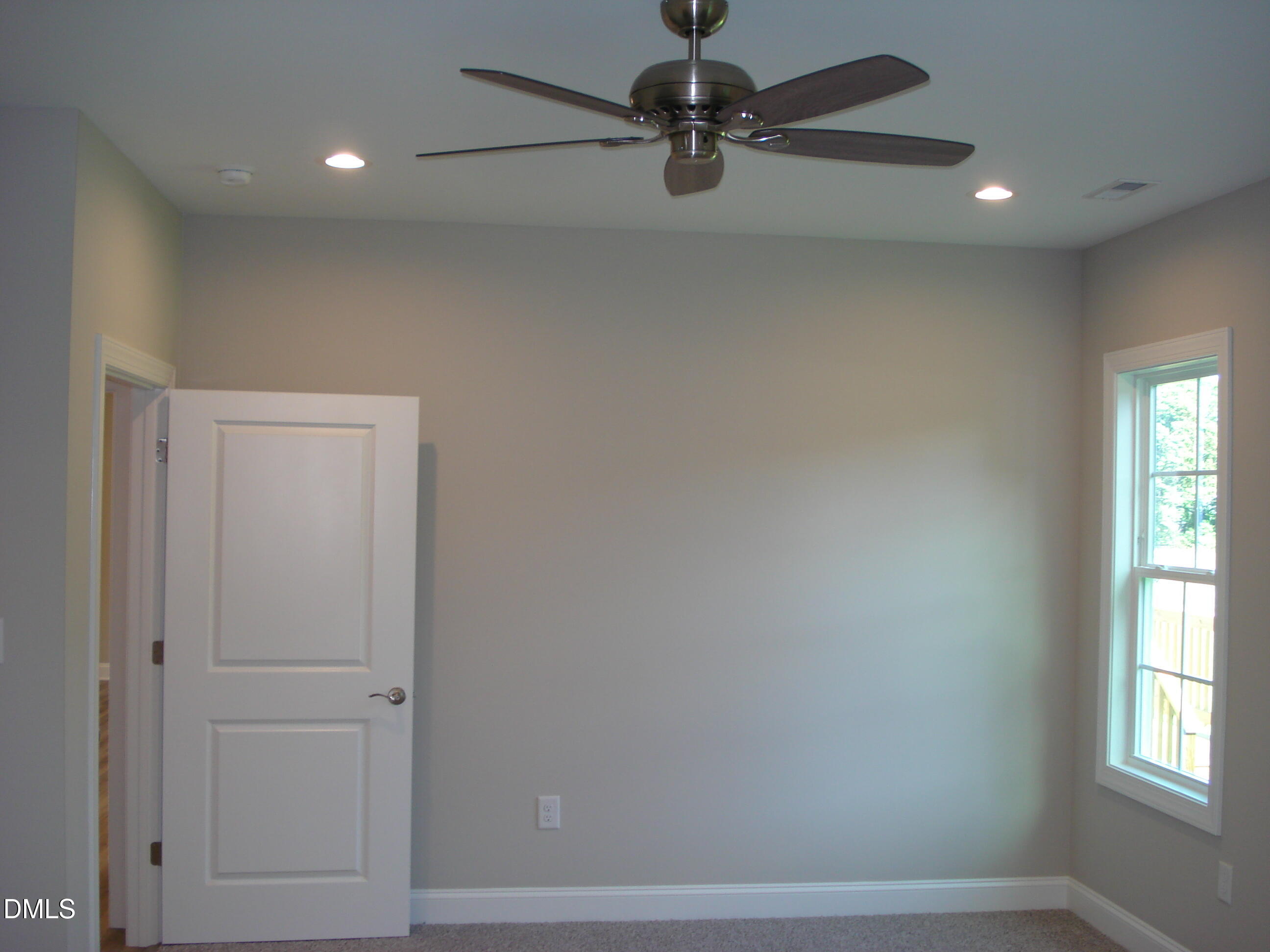 93 Big J Street Erwin, NC 28339 - Photo 35 of 56 an empty room with a window and a fan