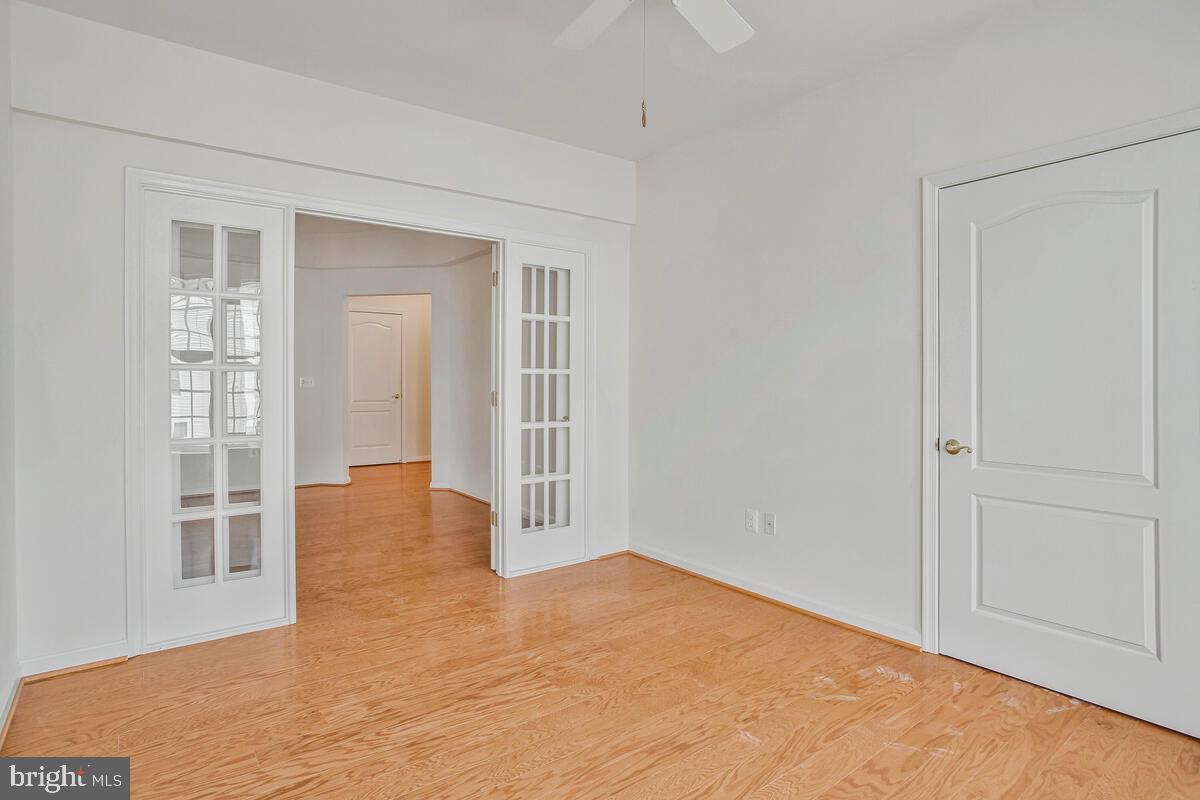 7315 Brookview Road, Unit 302 Elkridge, MD 21075 - Photo 16 of 68 a view of an empty room with wooden floor and a window