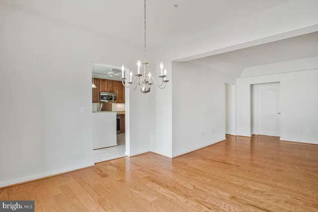 a bathroom with a granite countertop double vanity sink a mirror and a toilet