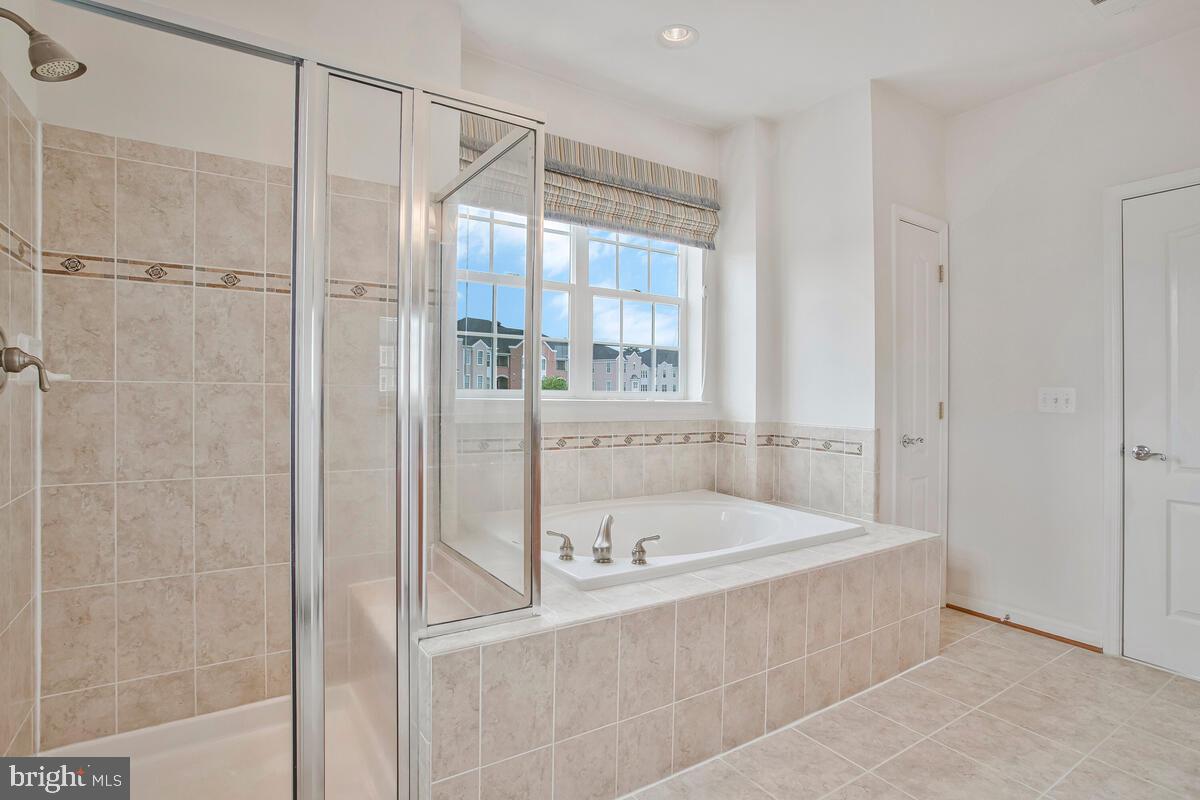 7315 Brookview Road, Unit 302 Elkridge, MD 21075 - Photo 30 of 68 a bathroom with a tub and shower