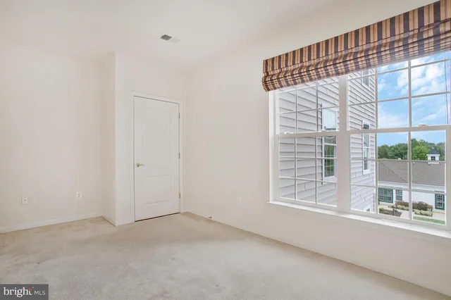 a dining area with a table chairs and a view of living room