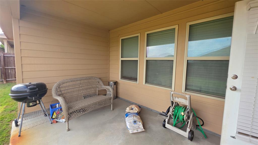 409 Samuel Street Denton, TX 76207 - Photo 35 of 40 a bedroom with a bed and a window