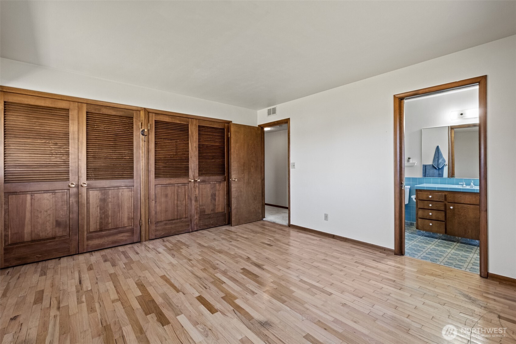 742 I Street Southwest Quincy, WA 98848 - Photo 13 of 28 an empty room with wooden floor and a bathroom