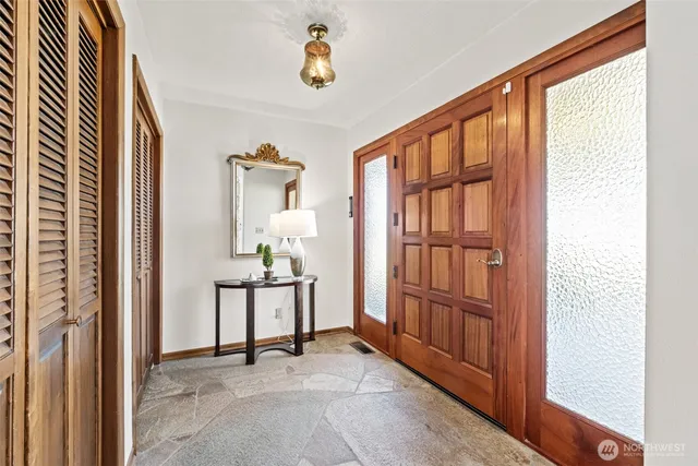 a view of an entryway with wooden floor