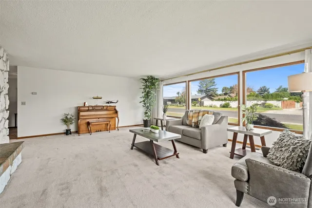 a living room with furniture and a floor to ceiling window