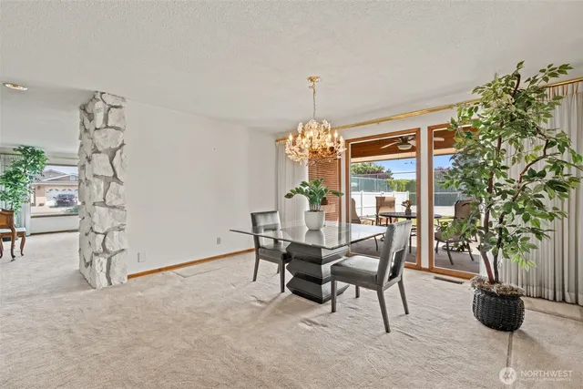 a view of a dining room with furniture and chandelier