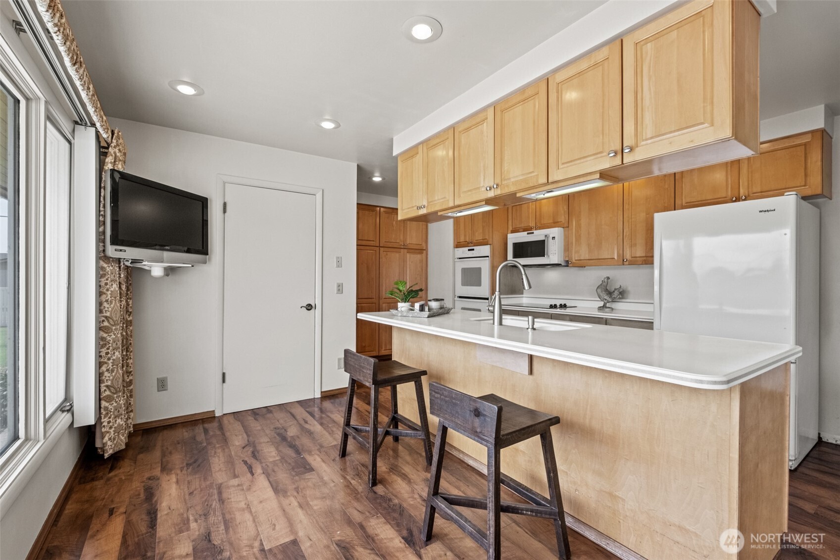 742 I Street Southwest Quincy, WA 98848 - Photo 8 of 28 a kitchen with stainless steel appliances a sink a stove a refrigerator cabinets and a dining table with wooden floor