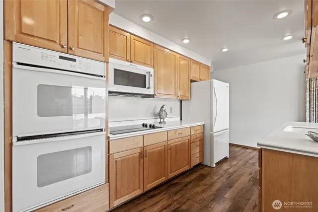 a kitchen with stainless steel appliances a refrigerator sink and microwave