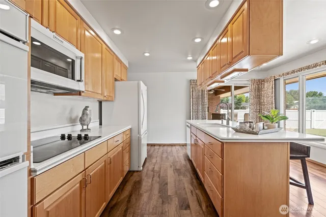 a kitchen with stainless steel appliances a sink stove and cabinets