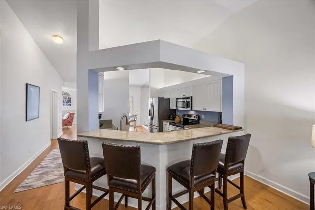 a dining room with a wooden table and chairs
