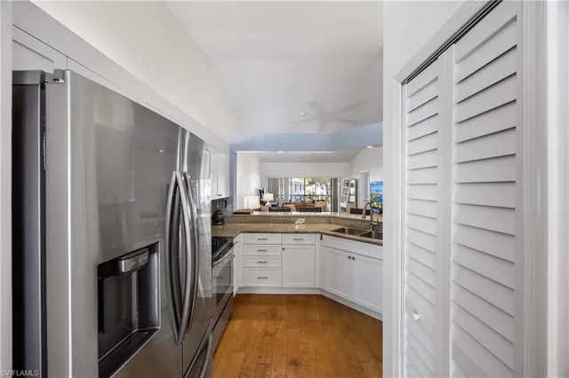 a kitchen with stainless steel appliances granite countertop a refrigerator and a sink
