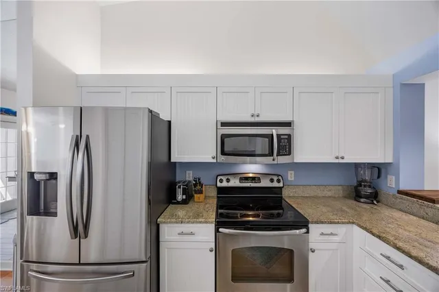 a kitchen with a refrigerator stove and microwave