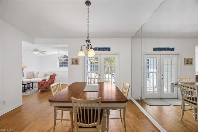a view of a dining room with furniture wooden floor and chandelier