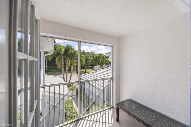 a view of a room with wooden floor and a window