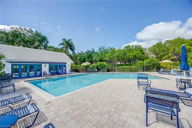 a view of a house with pool and chairs