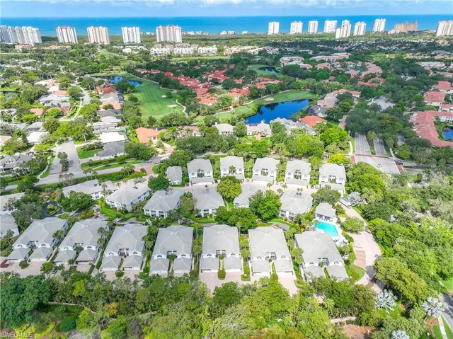 an aerial view of residential houses with outdoor space and street view