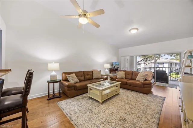 a living room with furniture ceiling fan and a rug
