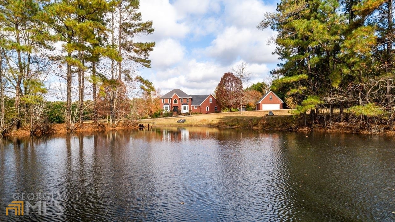 a view of residential houses with outdoor space and lake view